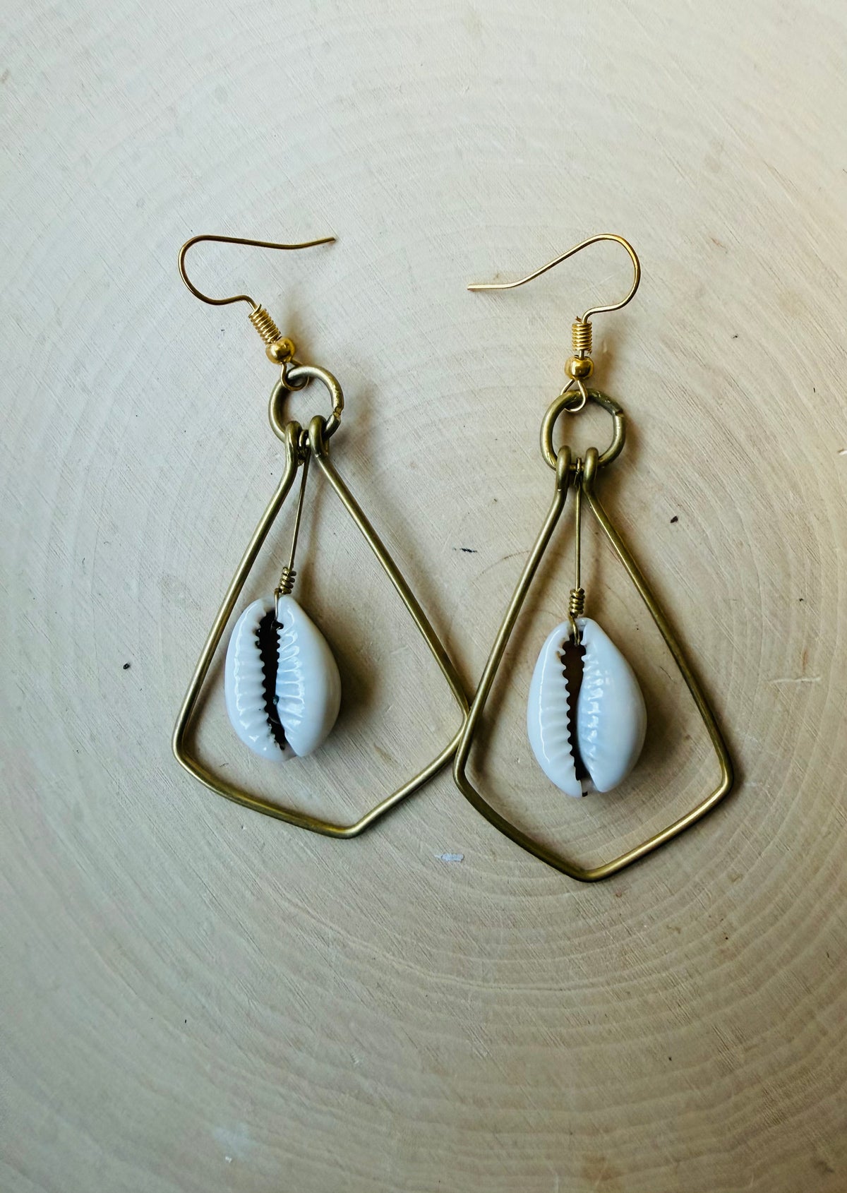 Brass cowrie swing earrings
